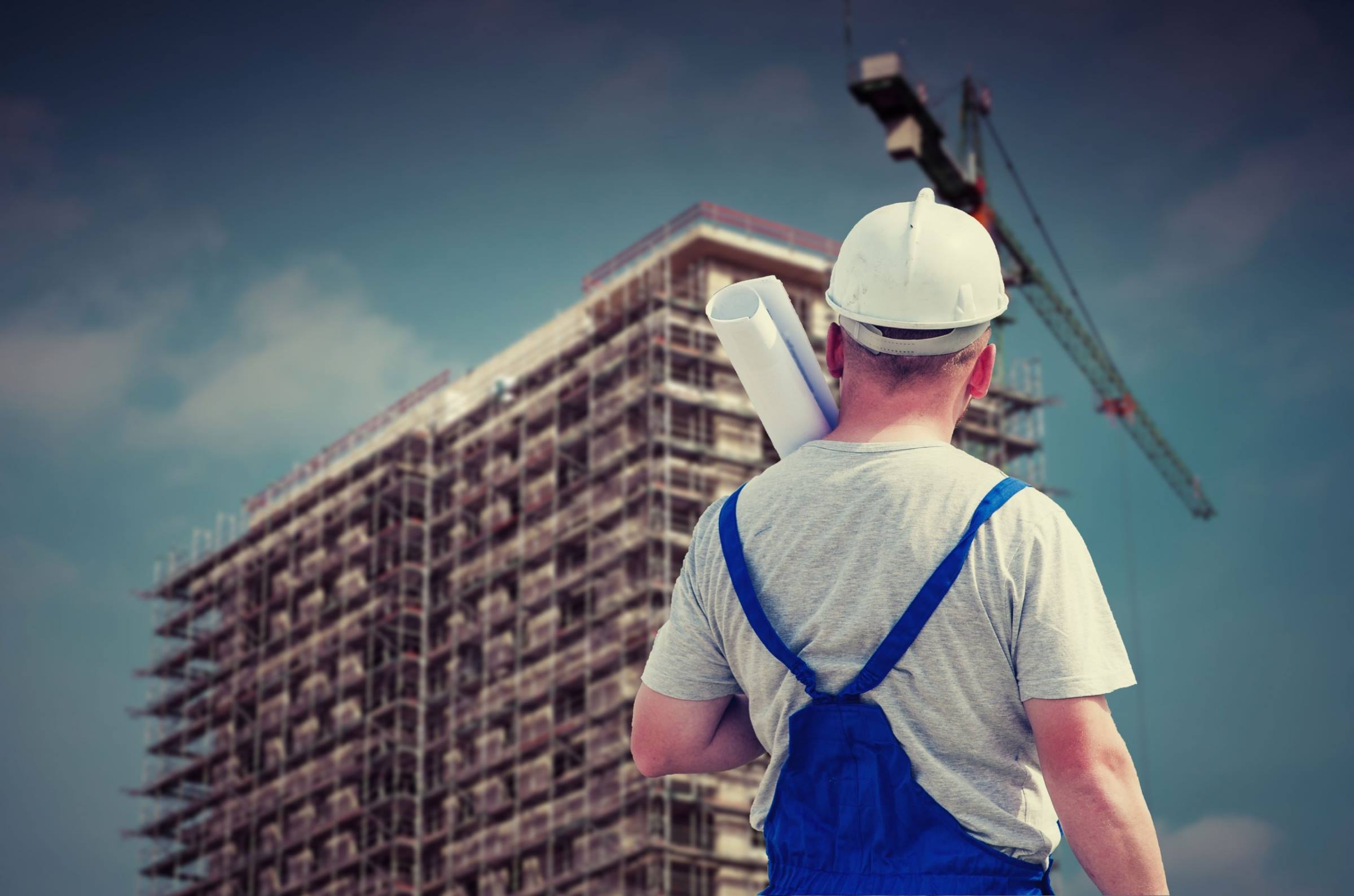 Worker builder plans crane high rise