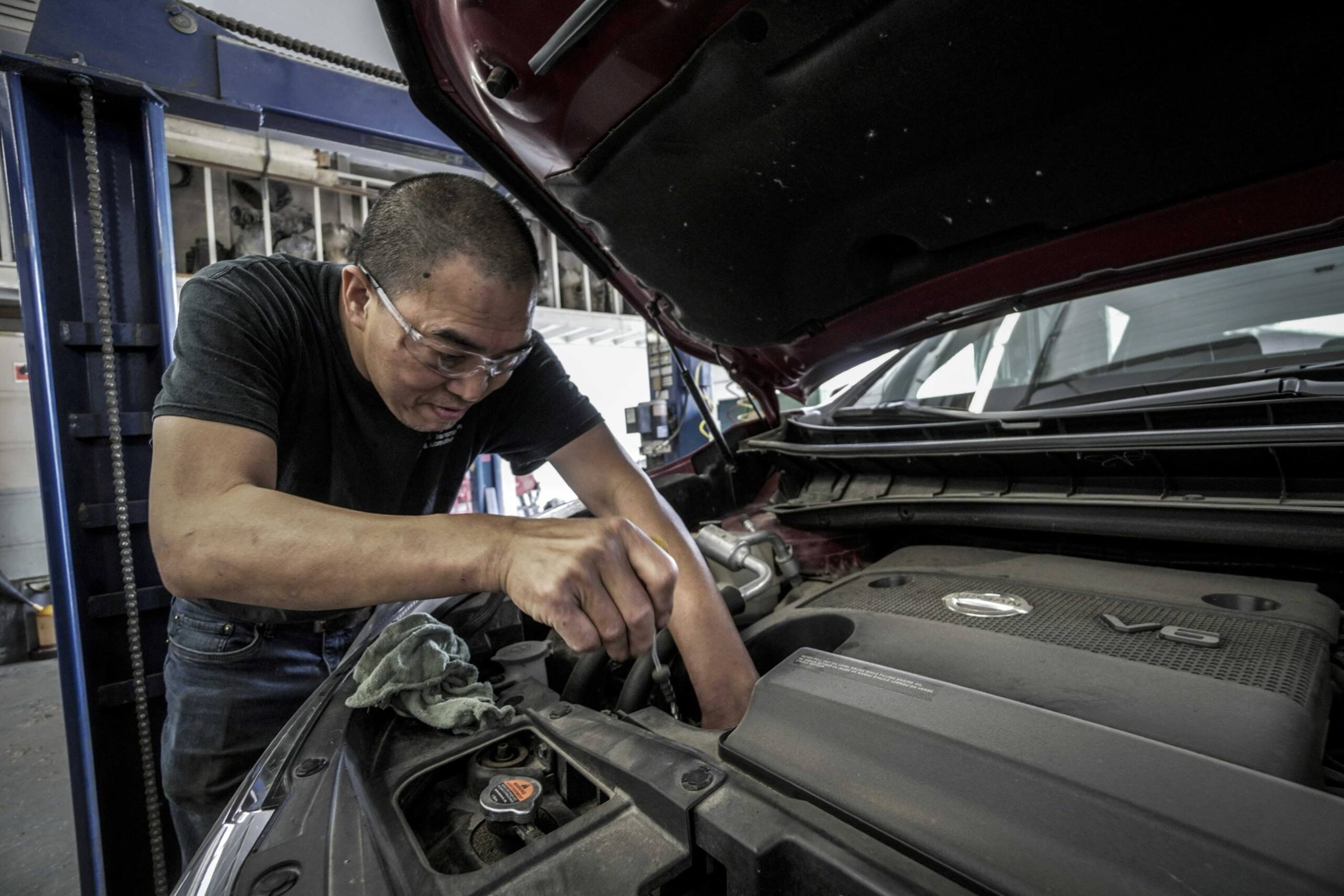 Auto mechanic repairing an engine