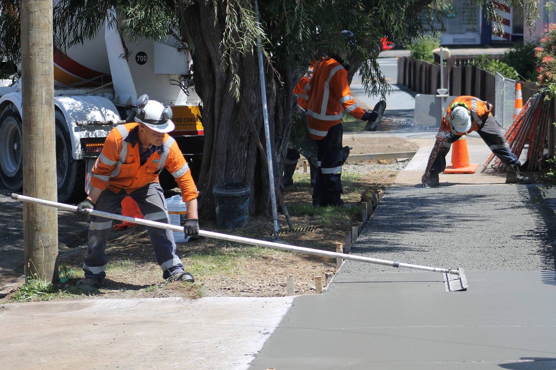 Workers laying concrete path