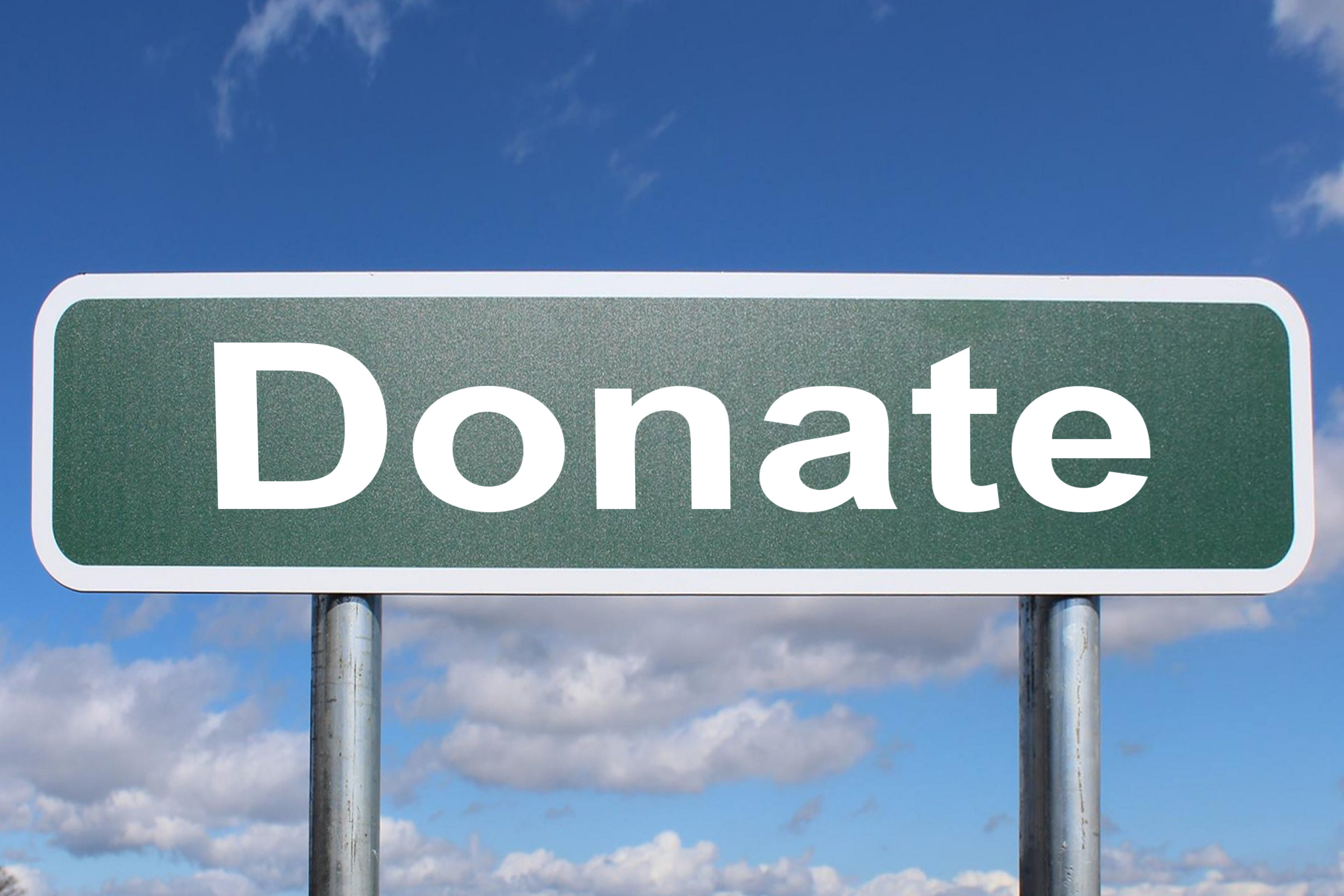 Please Donate Road Sign. Stock Photo, Picture and Royalty Free