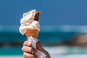 Ice cream cone melting on the beach