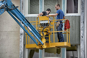 Construction workers on a hoist