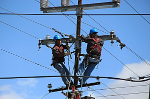 Two electrical workers on a pole