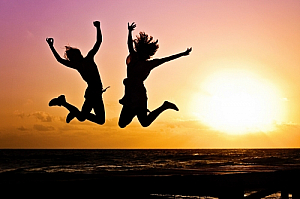 Silhouettes jumping on a beach