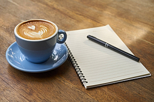 Cappuccino coffee and notebook